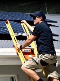 Solar installer inspecting Cairns rooftop